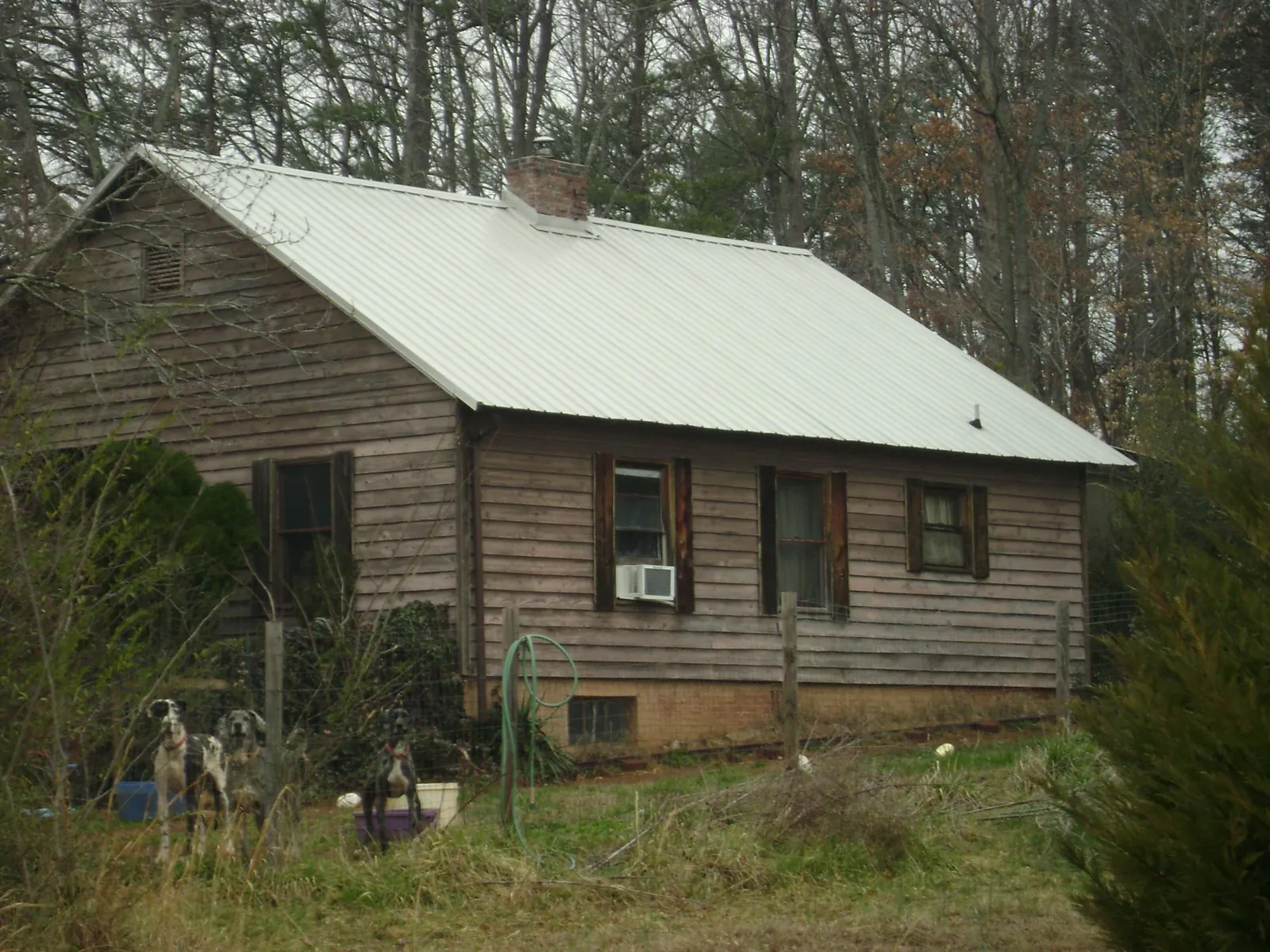 White metal roof on an old wood sided farmhouse, from a Metal Roof Installation job in Ludlow